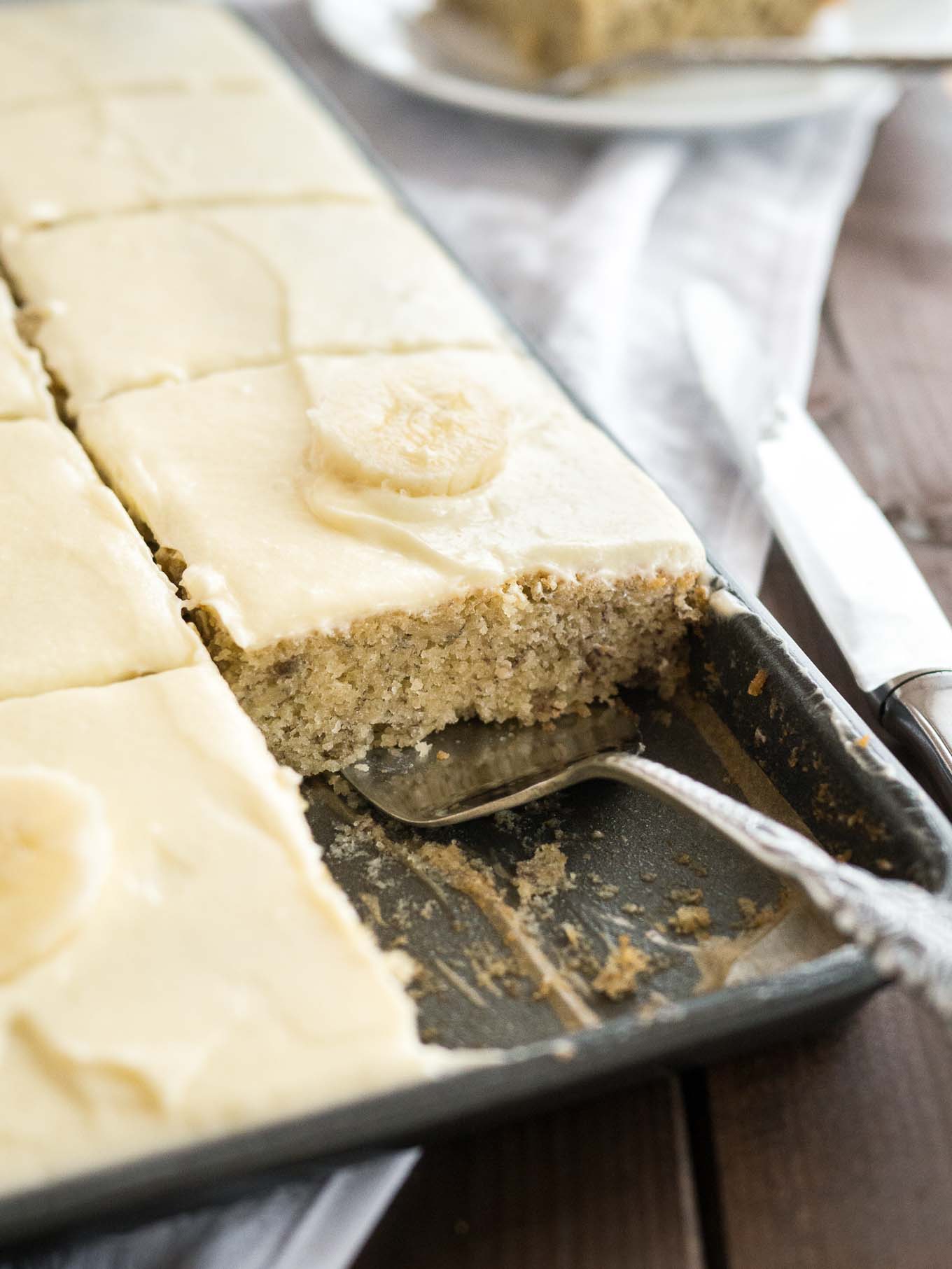 Easy Banana Cake - this fluffy and moist sheet cake has a mascarpone frosting on top and is ready in under 30 mins! A perfect cake to use overripe bananas.