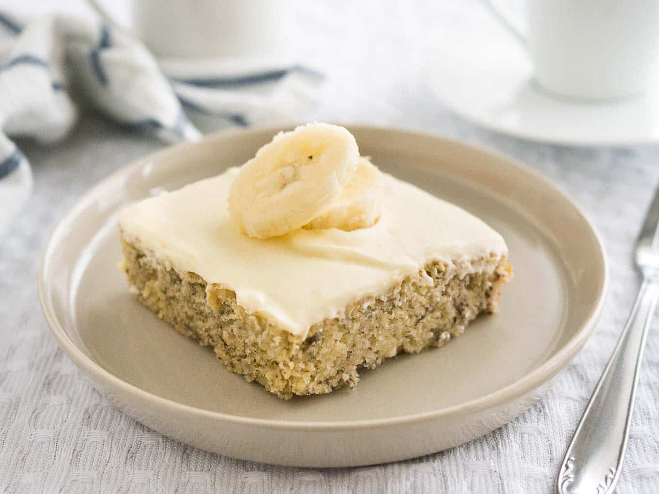 Easy Banana Cake - this fluffy and moist sheet cake has a mascarpone frosting on top and is ready in under 30 mins! A perfect cake to use overripe bananas.
