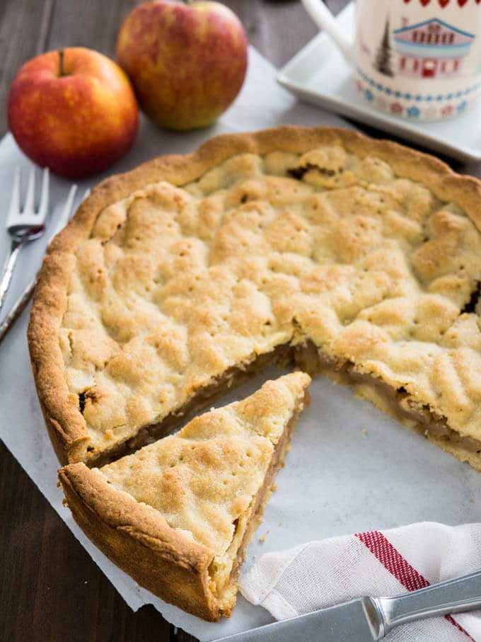 Covered German Apple Cake is one of the best apple cakes! Filled with cinnamon-seasoned apple chunks and topped with a vanilla shortbread crust. You can get this cake in every German bakery!