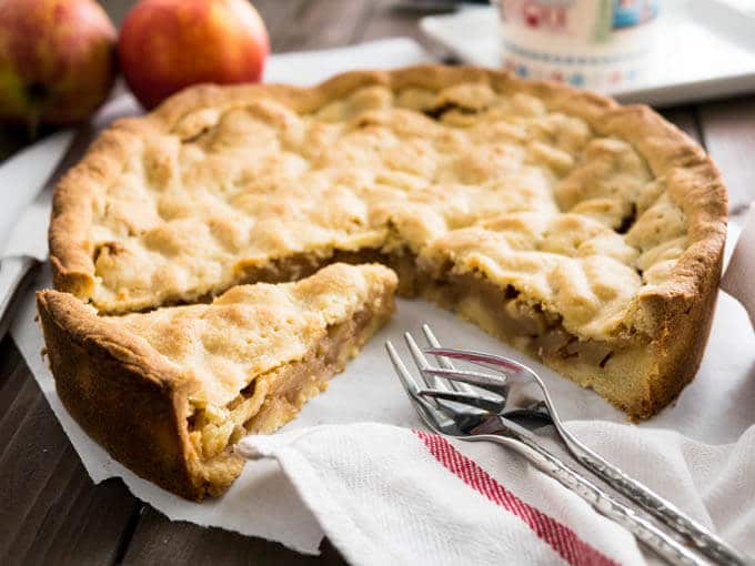 Covered German Apple Cake is one of the best apple cakes! Filled with cinnamon-seasoned apple chunks and topped with a vanilla shortbread crust. You can get this cake in every German bakery!