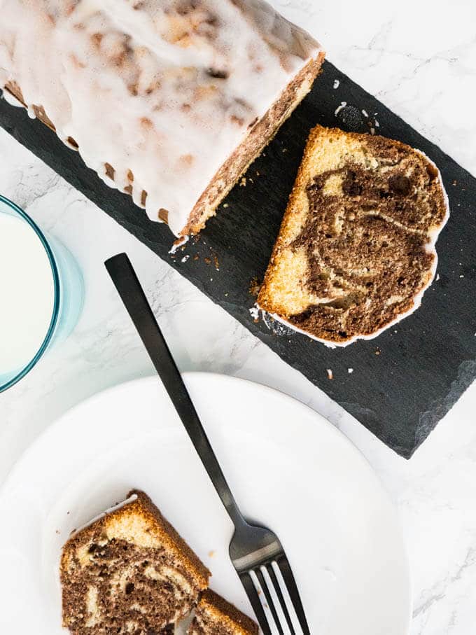 Marbled Orange Pound Cake is made from two different orange infused batters! This delicious cake has a lemon-flavored icing on top and tastes great with a cup of coffee.