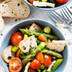 This warm Asparagus Garlic Bread Salad is made with sweet cherry tomatoes, crispy homemade ciabatta bread, and green asparagus! A perfect recipe for spring.
