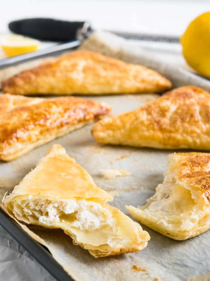 Lemon Puff Pastry Pockets are a perfect summer treat! Crispy caramelized puff pastry with a lemon & ricotta cheesecake filling.