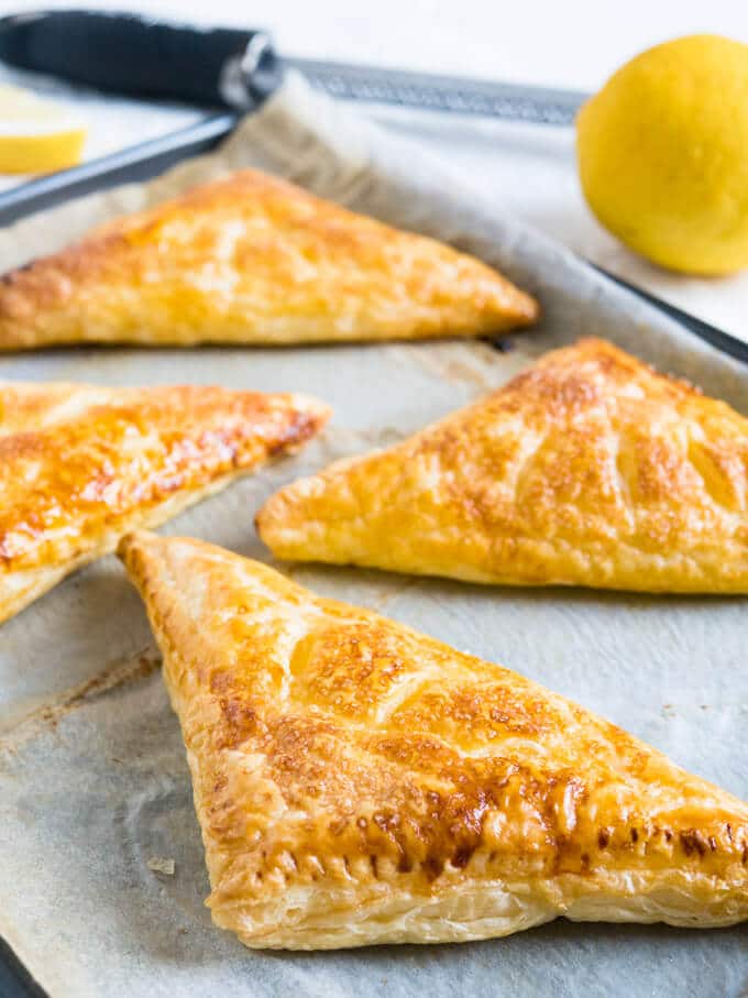 Lemon Puff Pastry Pockets are a perfect summer treat! Crispy caramelized puff pastry with a lemon & ricotta cheesecake filling.