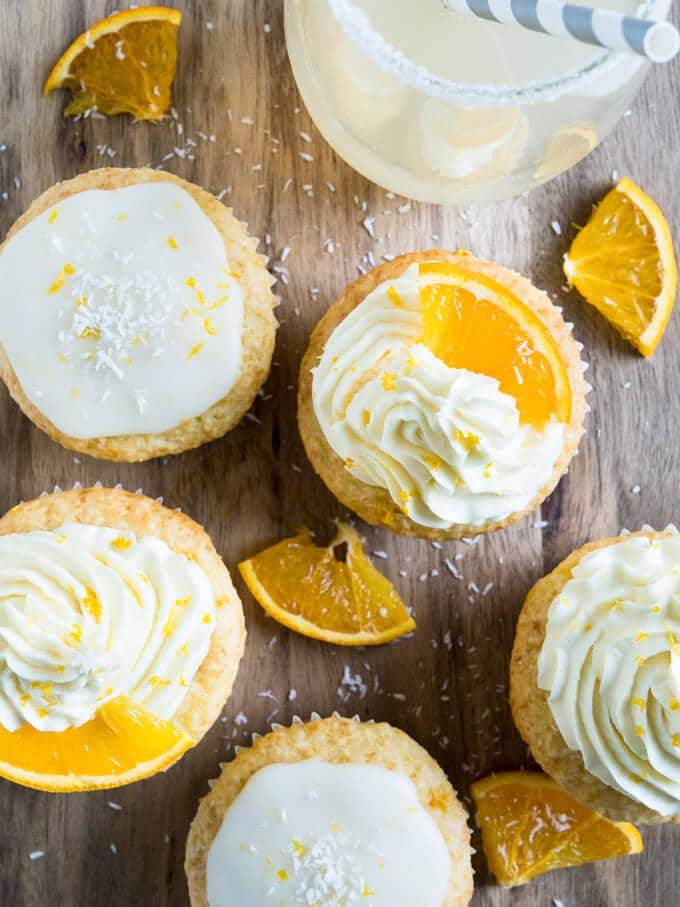 These Coconut Orange Creamsicle Cupcakes are a tropical taste explosion! An orange-infused coconut vanilla cupcake topped w/ orange buttercream or glaze. 