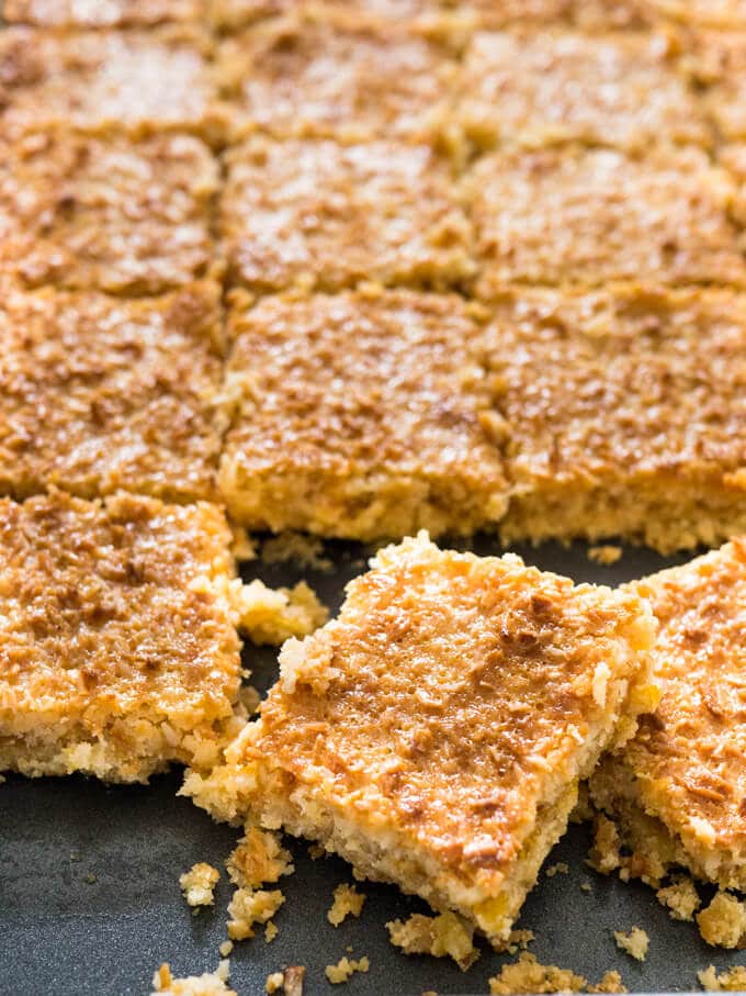 Tropical Coconut Squares taste like candy bars! Three delicious layers topped with sweetened condensed milk make this dessert a naughty little treat.