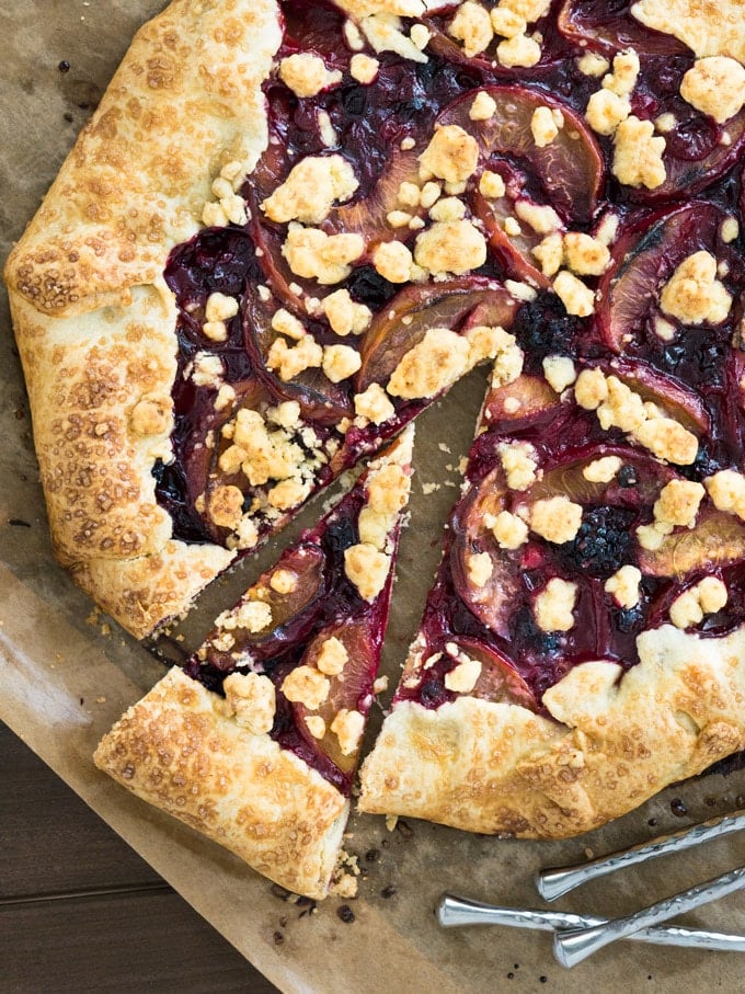 An easy Crostata with Peaches & Berries. Also known as galette, rustic pie or rustic tart. Served with a big dollop of vanilla ice cream, this is my go-to summer dessert!