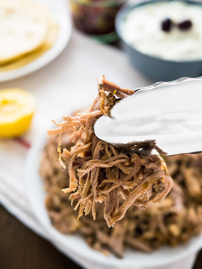 The best Slow Cooker Pulled Pork Gyros - made with my Greek Gyros spice mixture! This easy recipe is perfect for Greek-Style Tacos or simple Sandwichs with coleslaw.