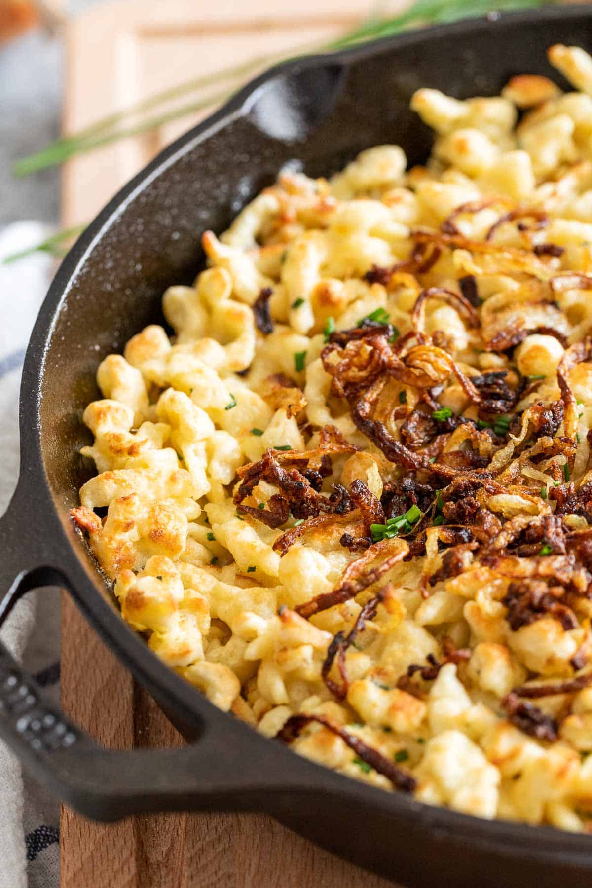 A skillet filled with cheese spaetzle.
