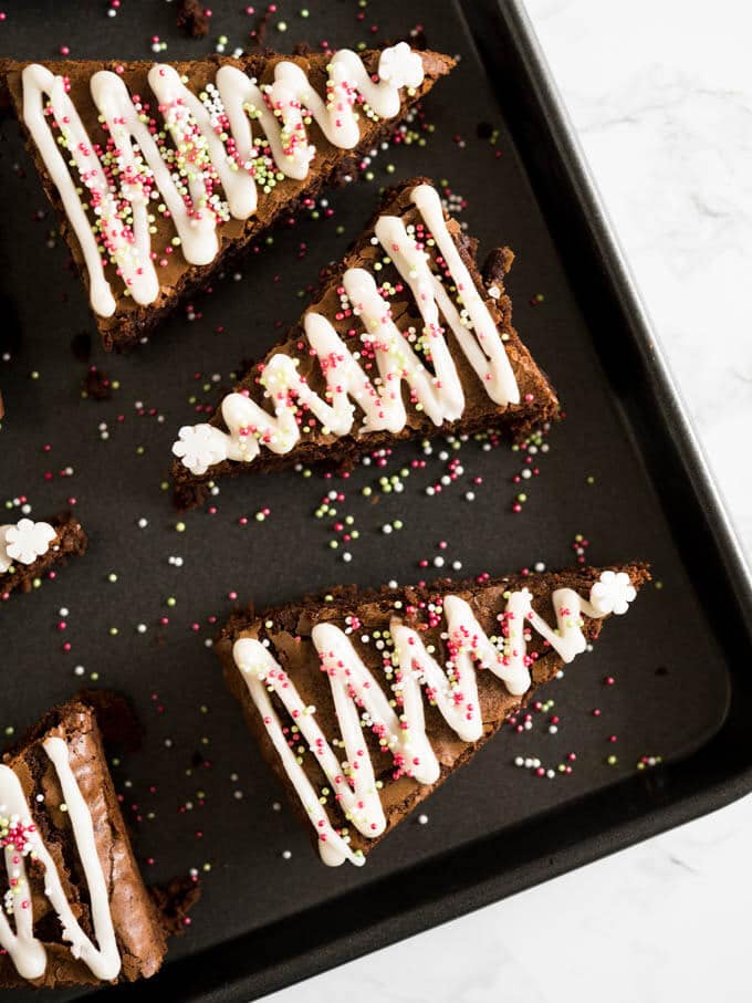 These Gingerbread Christmas Brownies take just minutes to put together! Add a seasonal spin to classic fudgy brownies with an easy semi-from-scratch recipe for Christmas Tree Brownies made with gingerbread spice and decorated with lots of sprinkles.