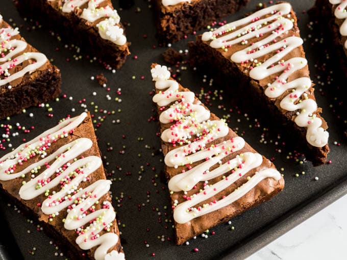 These Gingerbread Christmas Brownies take just minutes to put together! Add a seasonal spin to classic fudgy brownies with an easy semi-from-scratch recipe for Christmas Tree Brownies made with gingerbread spice and decorated with lots of sprinkles.