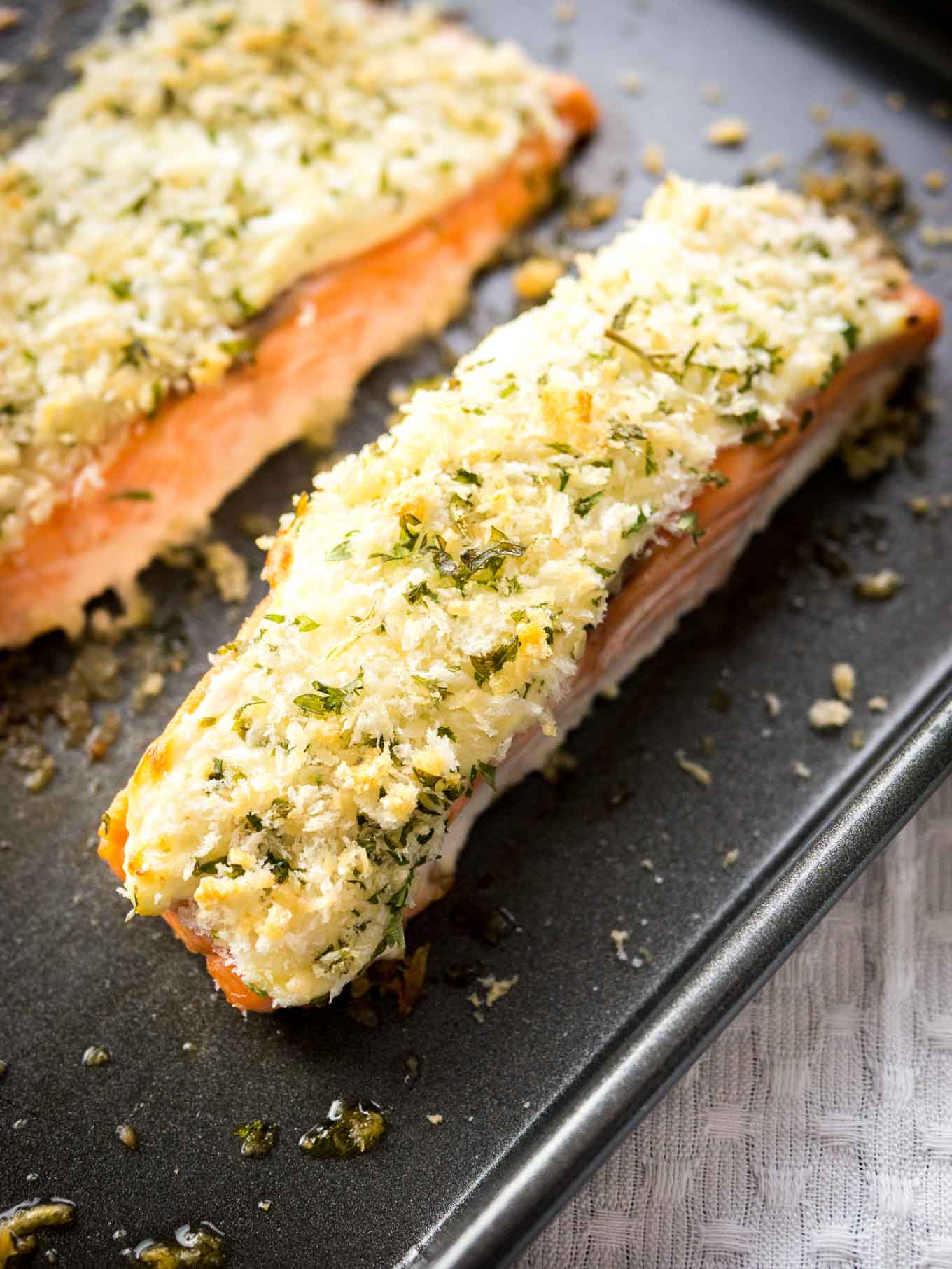 This Horseradish Parmesan crusted Salmon is baked in the oven and only takes 20 minutes to make. A dinner fancy enough for guests but also easy enough for weeknights!