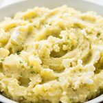 This Creamy Crock Pot Mashed Potatoes Recipe is SO easy and perfect to make ahead! A delicious slow cooker side dish for any meal throughout the fall and winter.