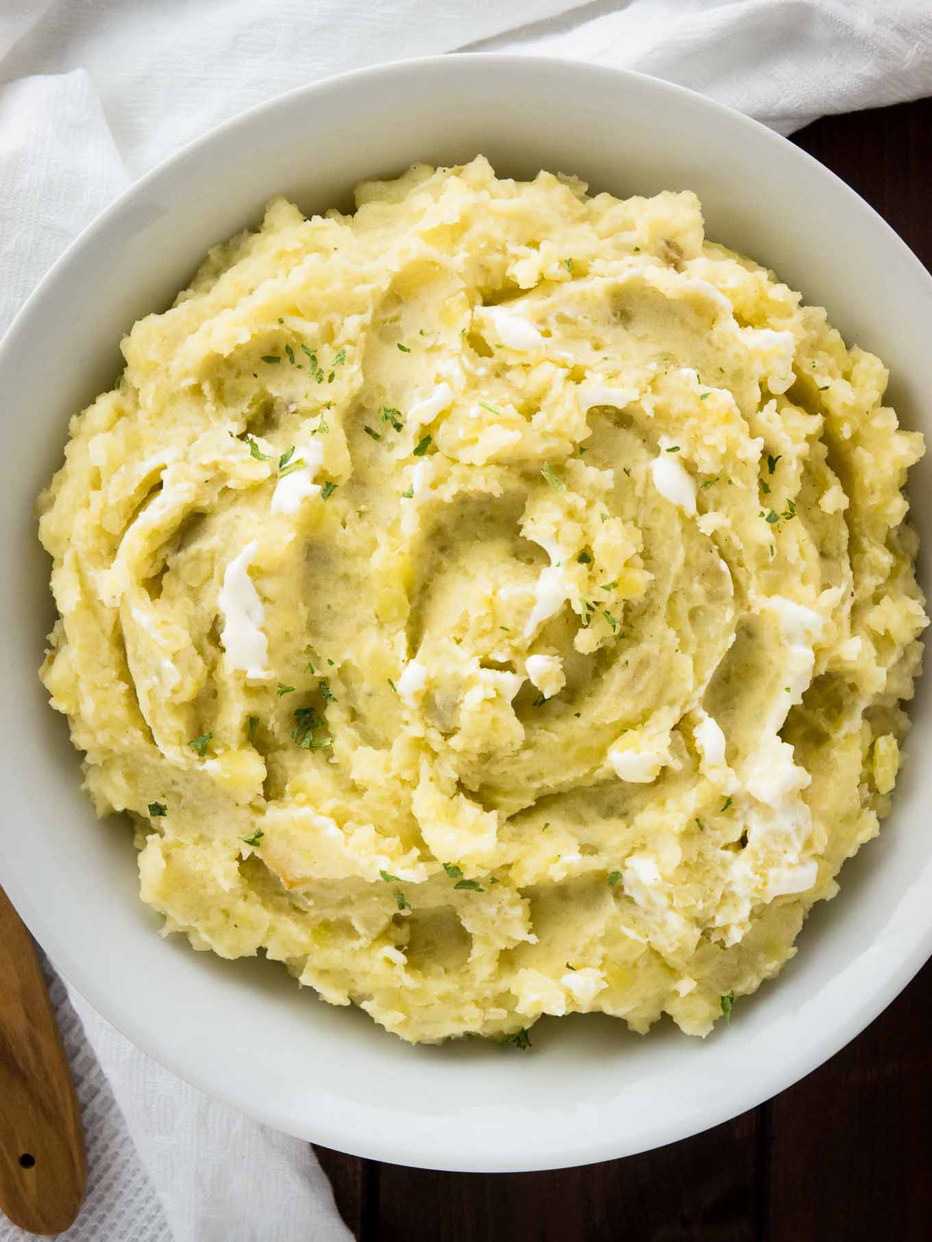 This Creamy Crock Pot Mashed Potatoes Recipe is SO easy and perfect to make ahead! A delicious slow cooker side dish for any meal throughout the fall and winter.