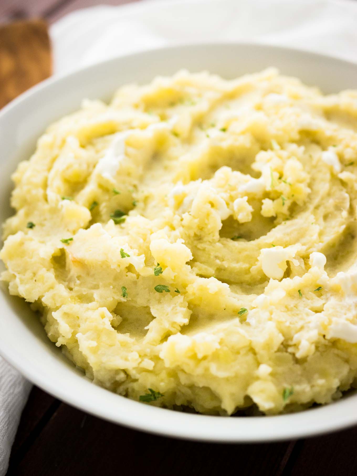 This Creamy Crock Pot Mashed Potatoes Recipe is SO easy and perfect to make ahead! A delicious slow cooker side dish for any meal throughout the fall and winter.