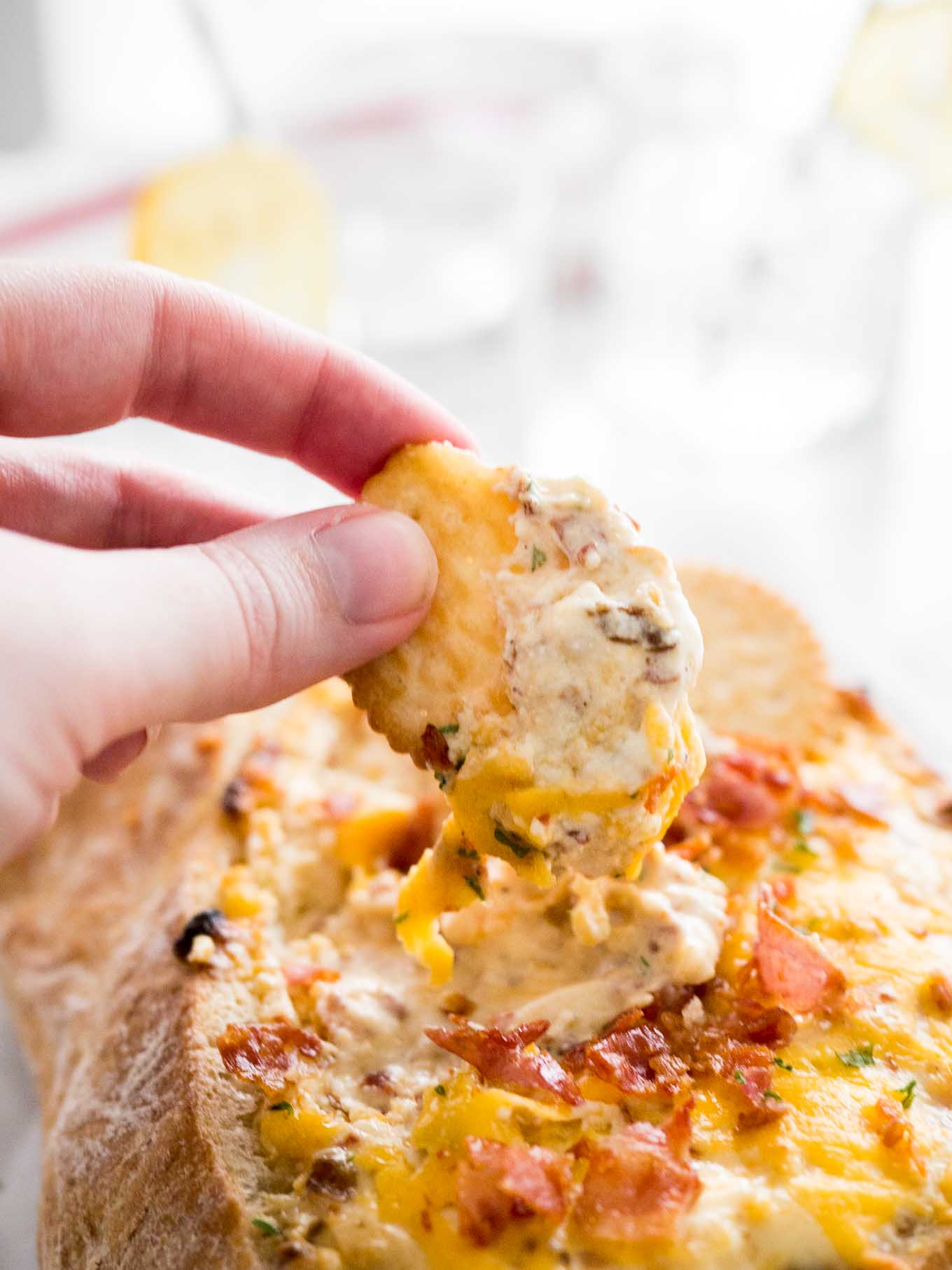 This Cheesy Bacon and Caramelized Onion Dip is sure to be a huge hit at your next party! A hot, creamy dip made with sweet onions, crispy bacon, and cheese that is so fast to make.
