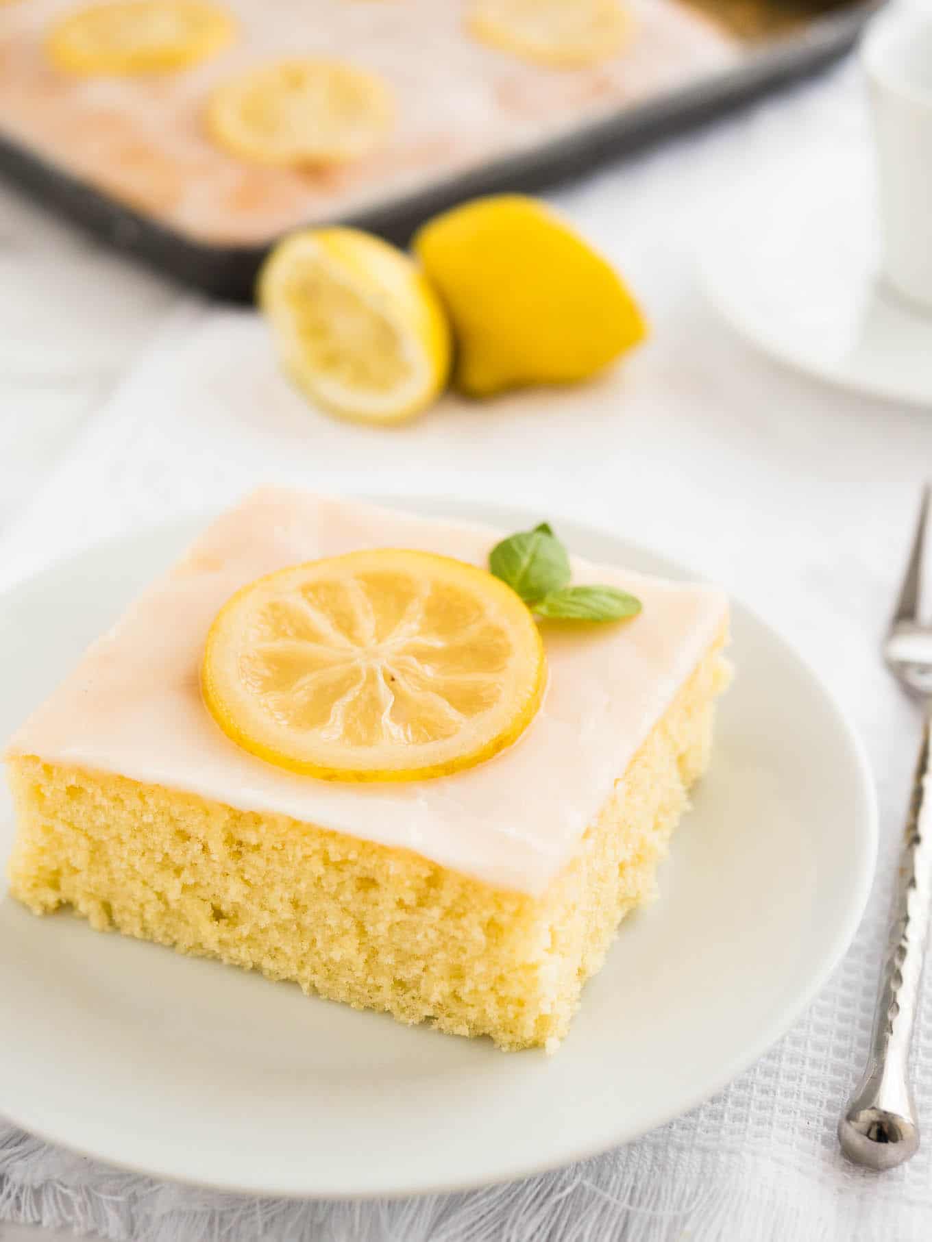 An easy lemon sheet cake recipe that is made in a 9x13-inch pan and has a delicious simple lemon glaze on top. This lemon cake tastes even better on the next day!