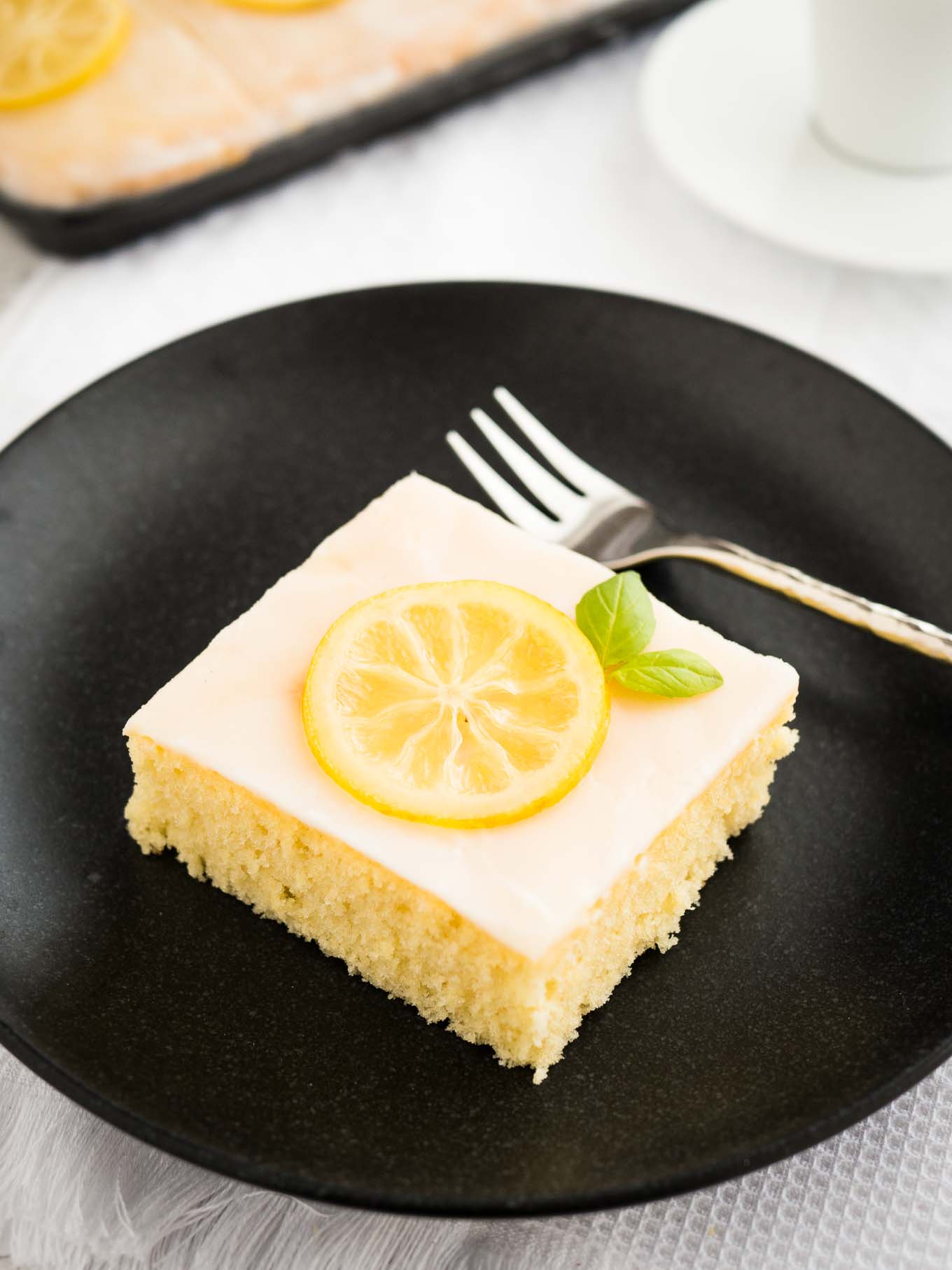 An easy lemon sheet cake recipe that is made in a 9x13-inch pan and has a delicious simple lemon glaze on top. This lemon cake tastes even better on the next day!