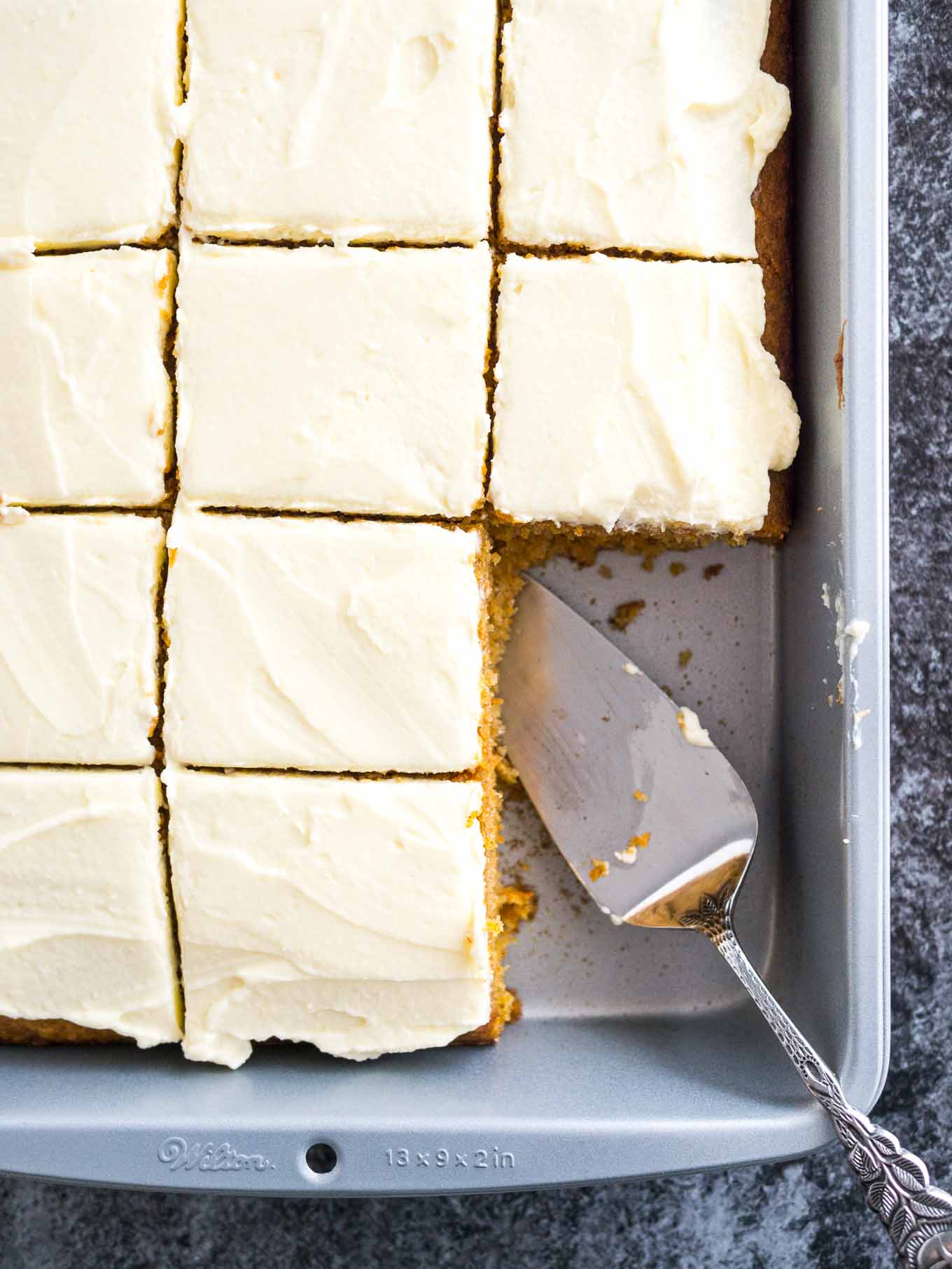 This easy Carrot Cake is deliciously moist and topped with a smooth cream cheese frosting! A nut-free sheet cake that is ready in 30 minutes and super simple to throw together.