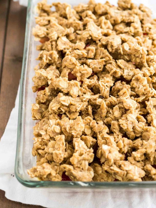 oatmeal streusel topping for rhubarb crisp in a glass baking dish on a wooden table