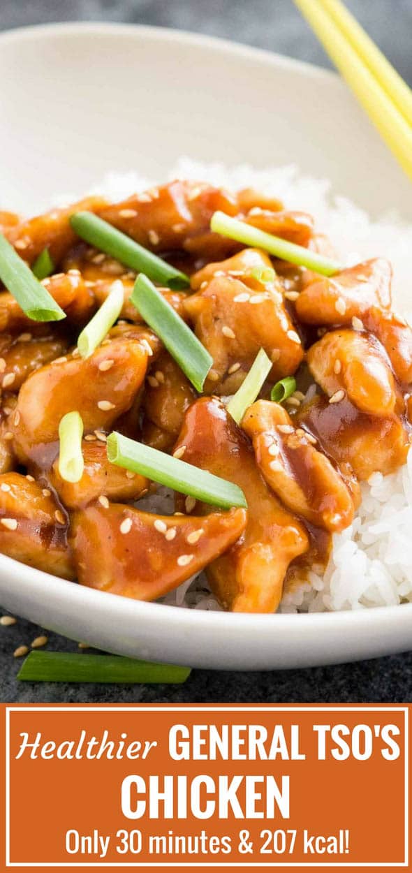 Close-up of grey bowl with rice and general tso\'s chicken, garnished with chives, with chopsticks.