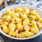 Authentic German Potato Salad is made with vinegar, broth, and oil and can be served warm or cold. A perfect side dish for any occasion from summer BBQs to family dinners!