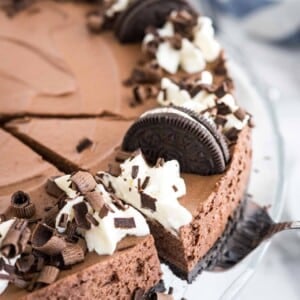 A slice of chocolate mousse cake being removed from the cake.