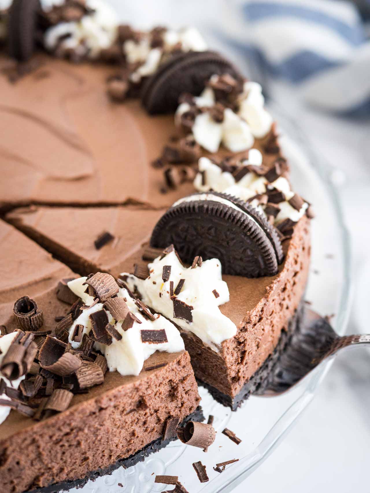 A slice of chocolate mousse cake being removed from the cake.