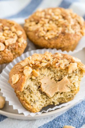 Peanut Butter Banana Muffins have a surprise inside and are so fluffy and moist. These easy banana muffins are filled with creamy peanut butter and topped with caramelized peanuts.