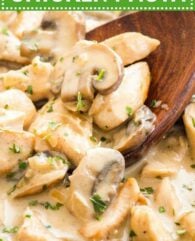 Close-up of Mushroom Chicken Pasta sauce with cream with a wooden cooking spoon in it, garnished with parsley