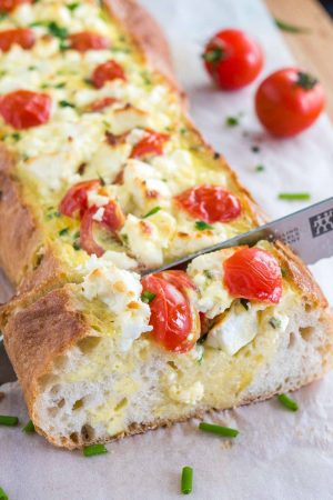 Tomato Feta Stuffed French Bread is so easy to make and bursting with fresh flavors! This is the ultimate appetizer for your next party!