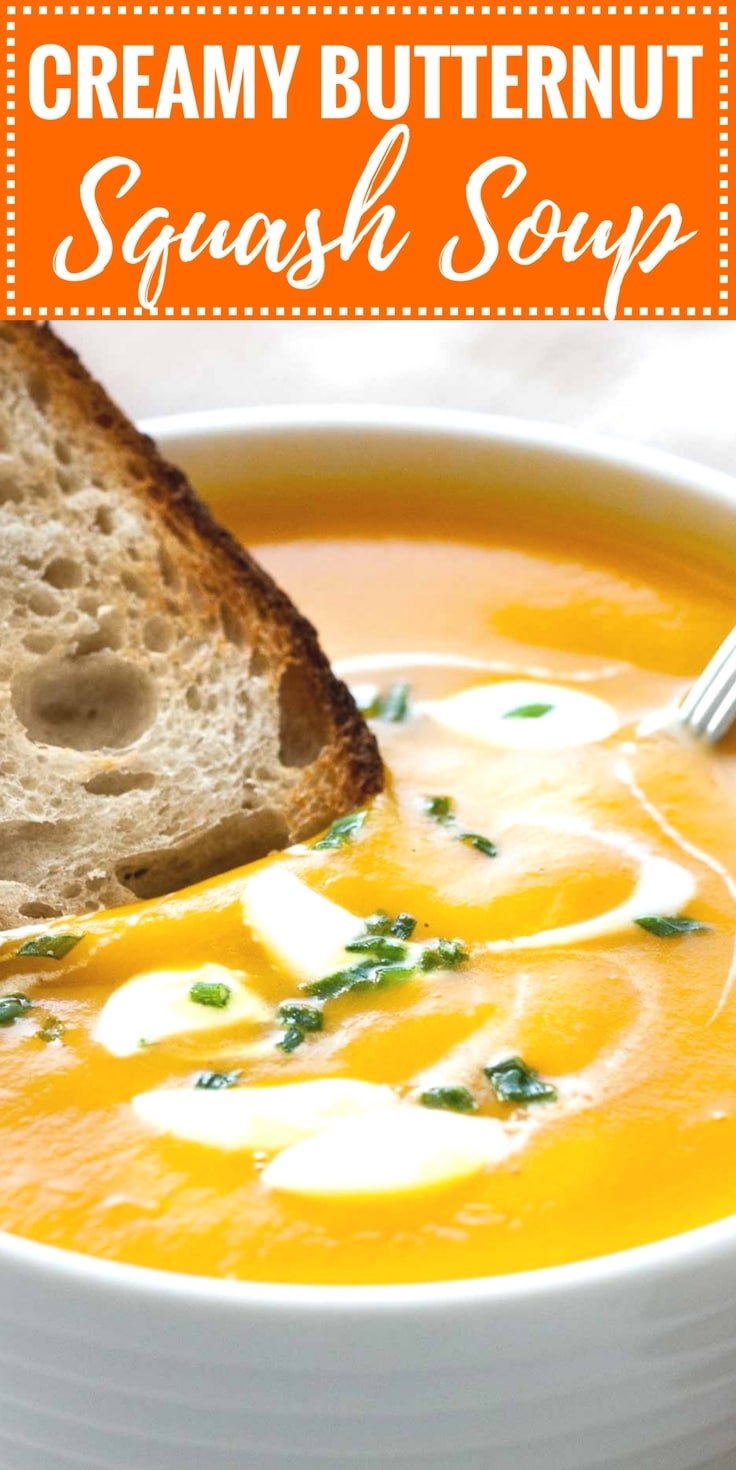 Image with text: Creamy butternut squash soup. Image: Close-up of a white bowl with butternut squash soup, with dollops of sour cream and chives, a spoon in it and a toasted slice of bread.