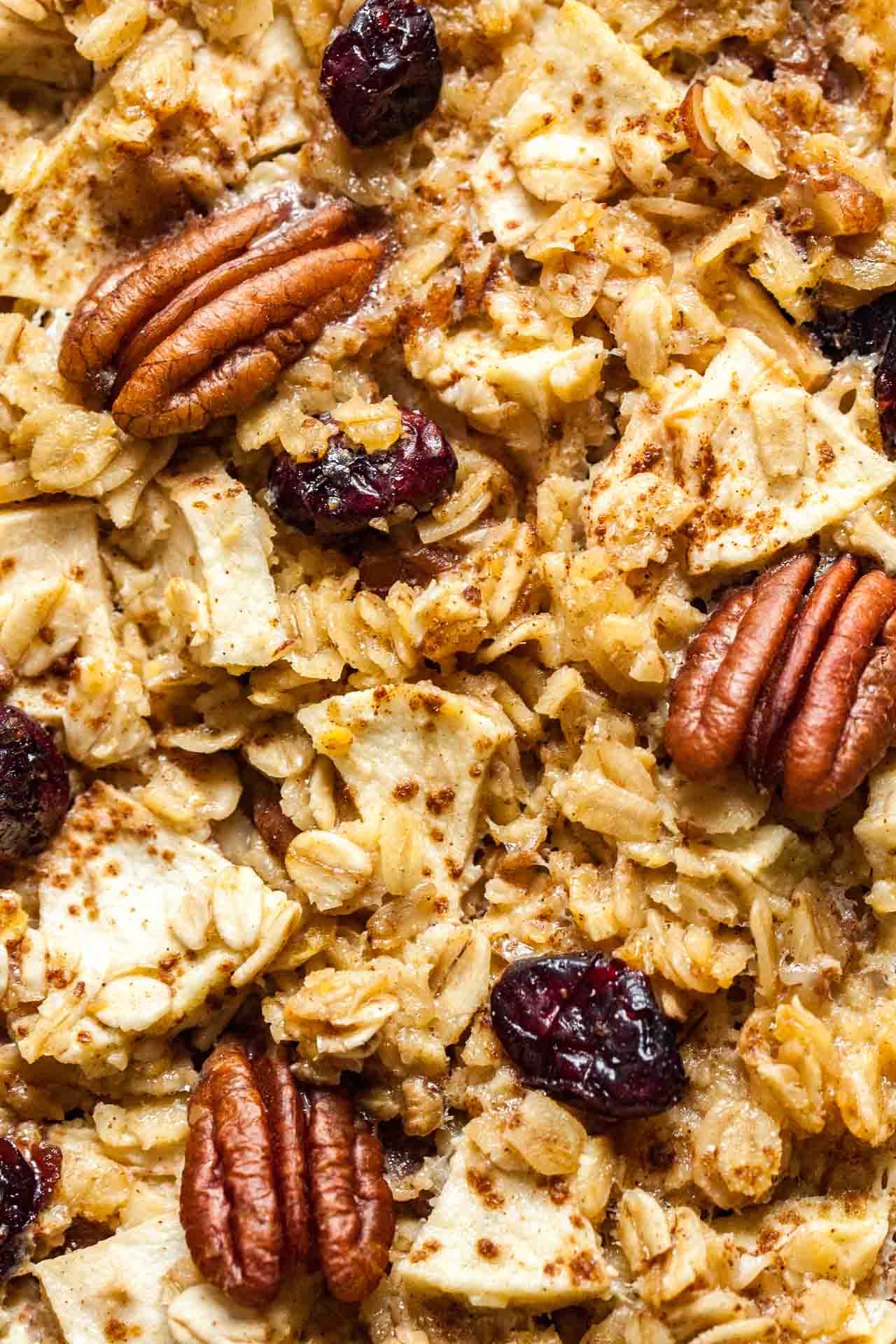 Close-up, top-down shot of baked oatmeal with apples, pecans and cranberries.