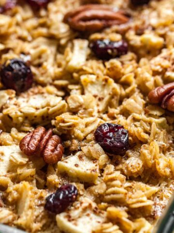 Close-up baked oatmeal with apples, pecans and cranberries.