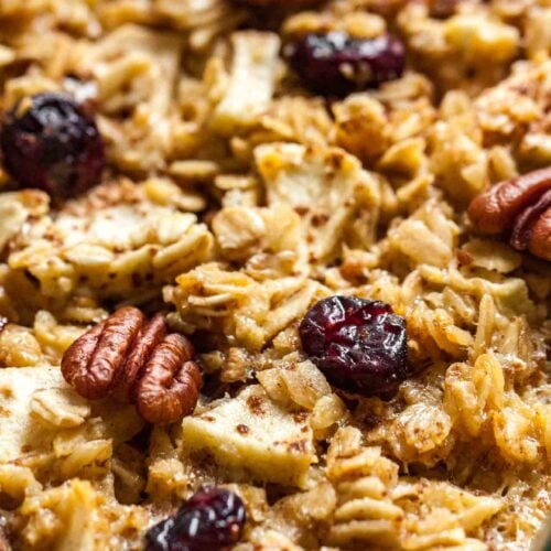 Close-up baked oatmeal with apples, pecans and cranberries.
