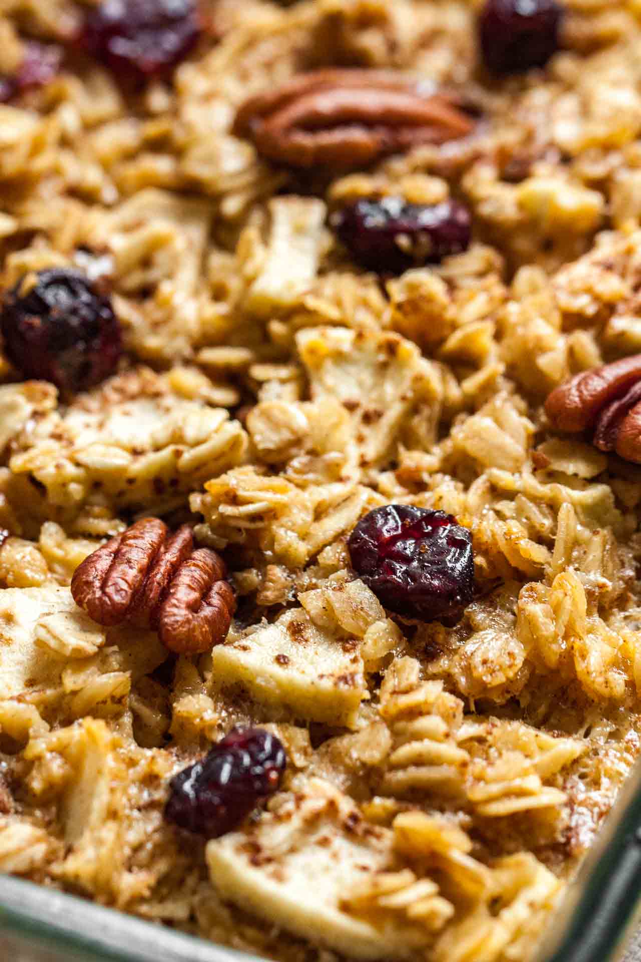 Close-up baked oatmeal with apples, pecans and cranberries.