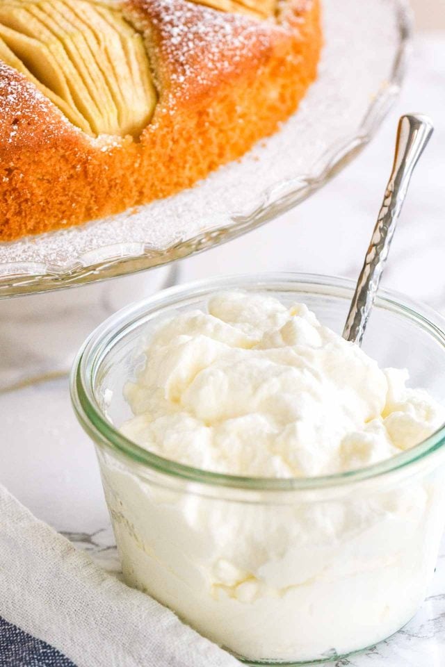 Whipped Cream in a glass jar with a spoon