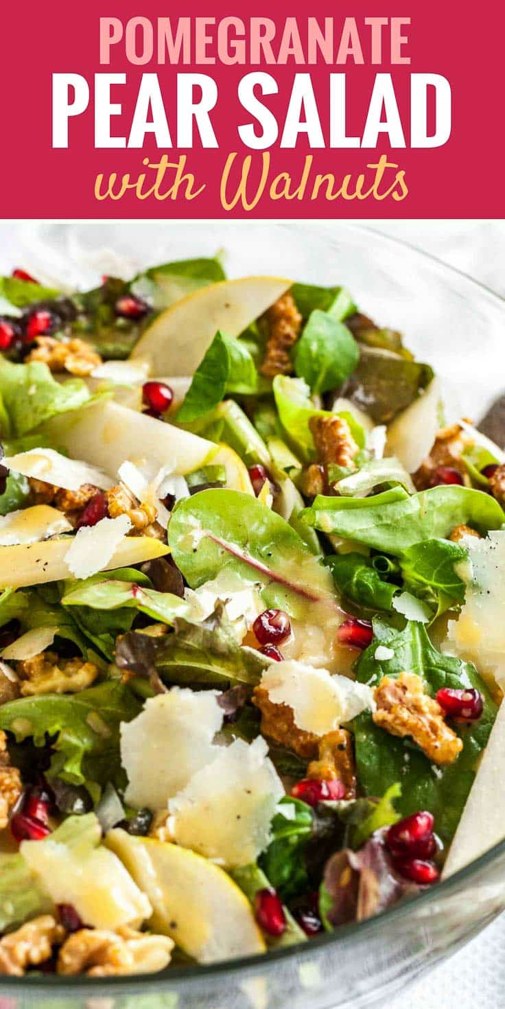 Picture with text: Pomegranate pear salad with walnuts, image: Close-up of pomegranate pear salad with walnut in a glass bowl.