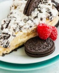 Banana Cream Cake with a homemade OREO cookie crust is the perfect No-Bake dessert for any occasion! Made with a luscious banana pudding filling made completely from scratch and topped with whipped OREO cream, this banana cream pie recipe is always a hit.