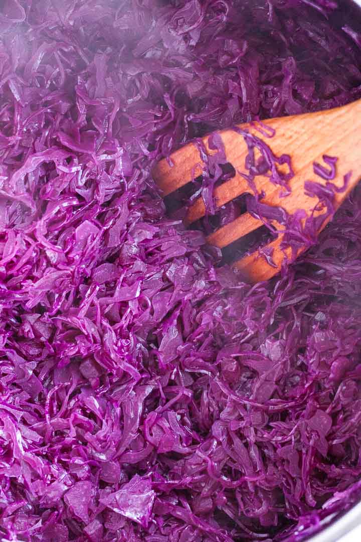 Red cabbage cooking in a dutch oven.