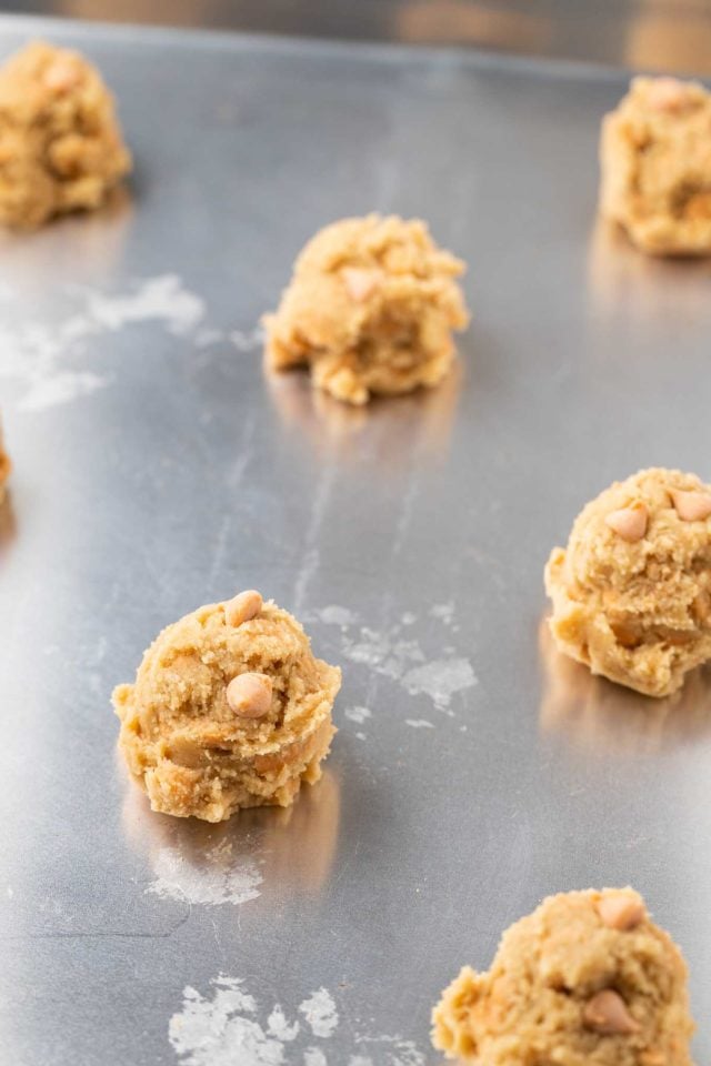 balls of butterscotch cookie dough on a baking sheet