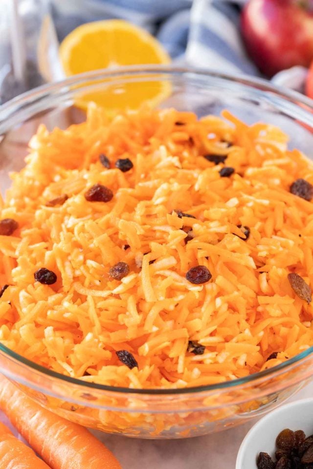 Carrot salad with raisins in a glass bowl