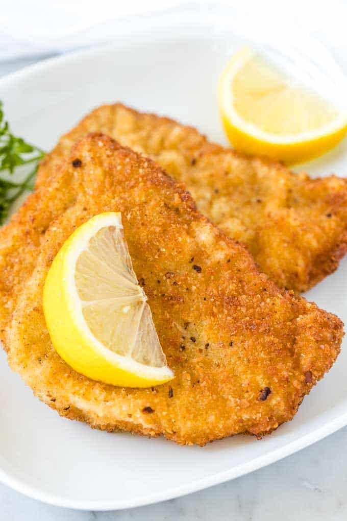 A plate of crispy German schnitzel with savory gravy