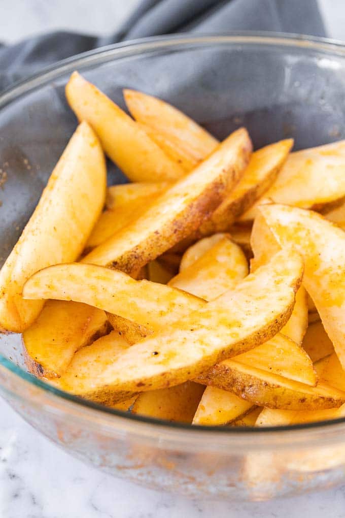 Cut Potato Wedges in a glass bowl.