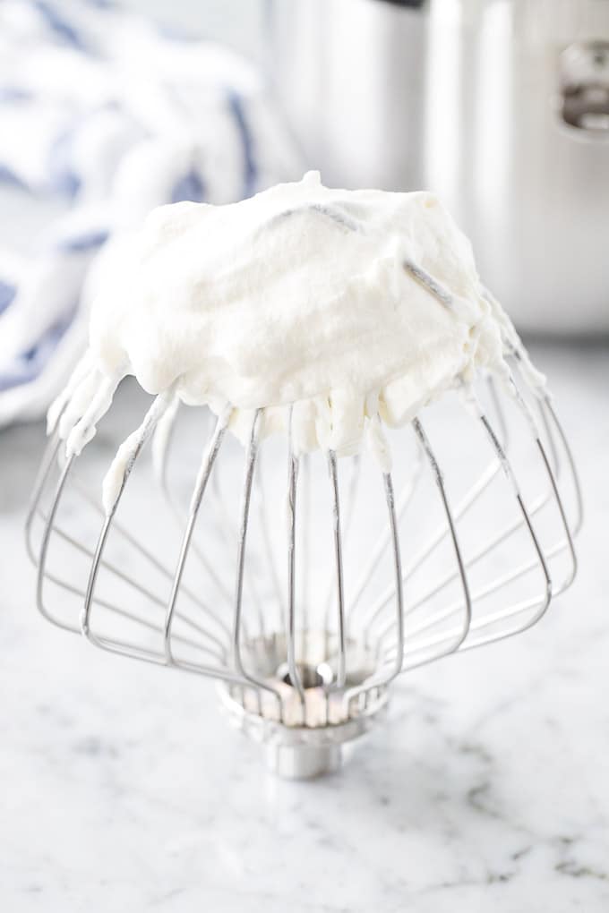 Whipped cream on a Kitchen Aid whisk.