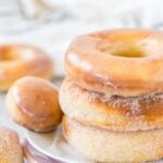 Stack of Air Fryer Donuts on a plate, both glazed and sugared