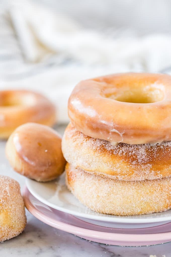 Stack of Air Fryer Donuts on a plate, both glazed and sugared