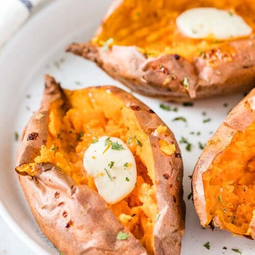 Air Fryer Sweet Potatoes on a plate topped with butter and parsley