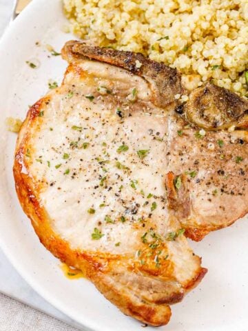 A plate of food, with Pork chop