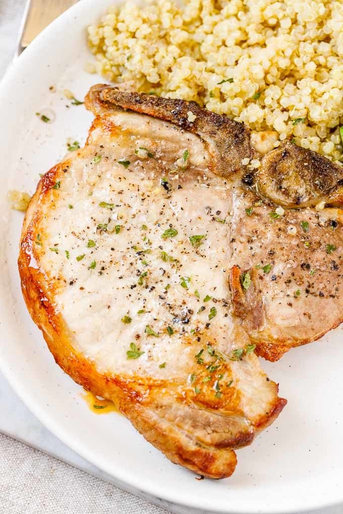 Close-up of Air Fryer Pork Chops with Quinoa on a plate.